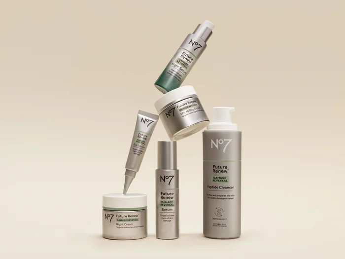 A woman smiling in front of a grey background