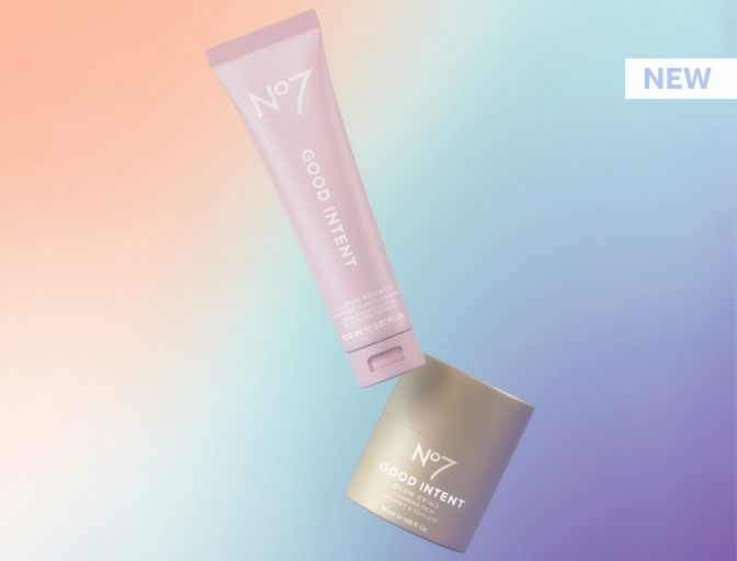 Ombre background with shades of peach, blue and purple. Two GOOD INTENT products falling, one purple tube and one toffee coloured pot. 'New' message in blue text on a white background on the top right of the page.