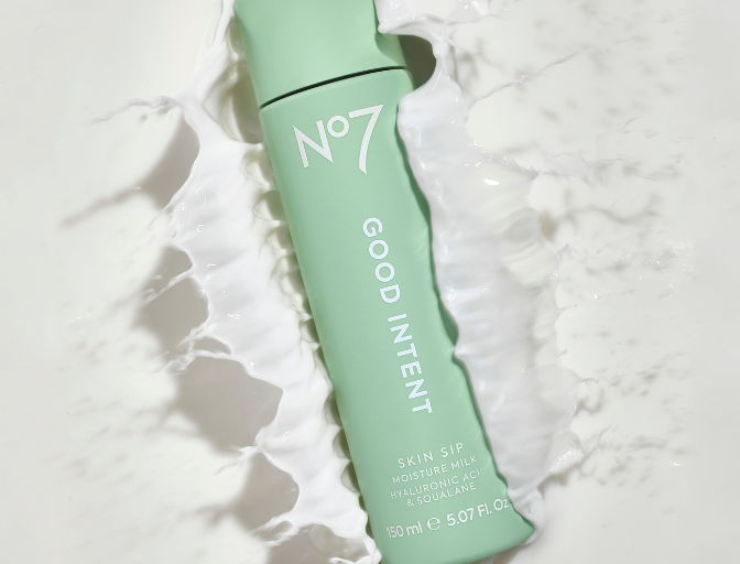 Green GOOD INTENT bottle splashing in a white liquid. Text on bottle reads 'No7 GOOD INTENT Skin Sip Moisture Milk'