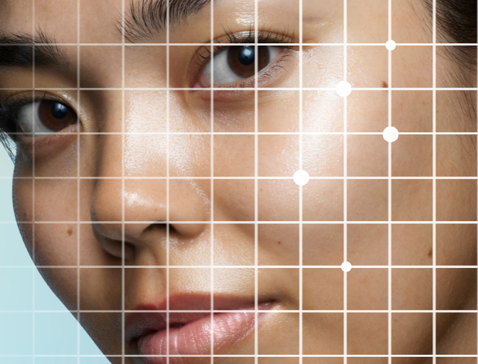 Close up image of a model, with a white grid and dots over the face to represent the skin analysis tool.