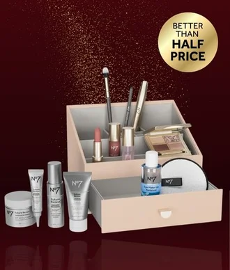 Image is a photograph of the No7 & Stackers The Best Of Beauty Collection gift on a maroon and black gradient background. A gold roundel reads 'Better than Half Price'